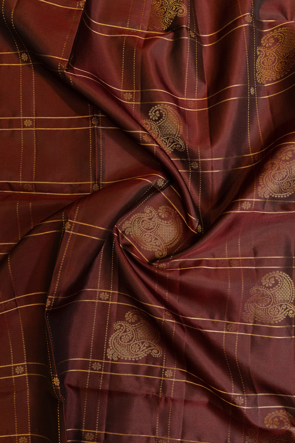 Close-up of maroon fabric with gold patterns