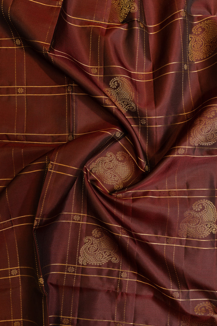 Close-up of maroon fabric with gold patterns