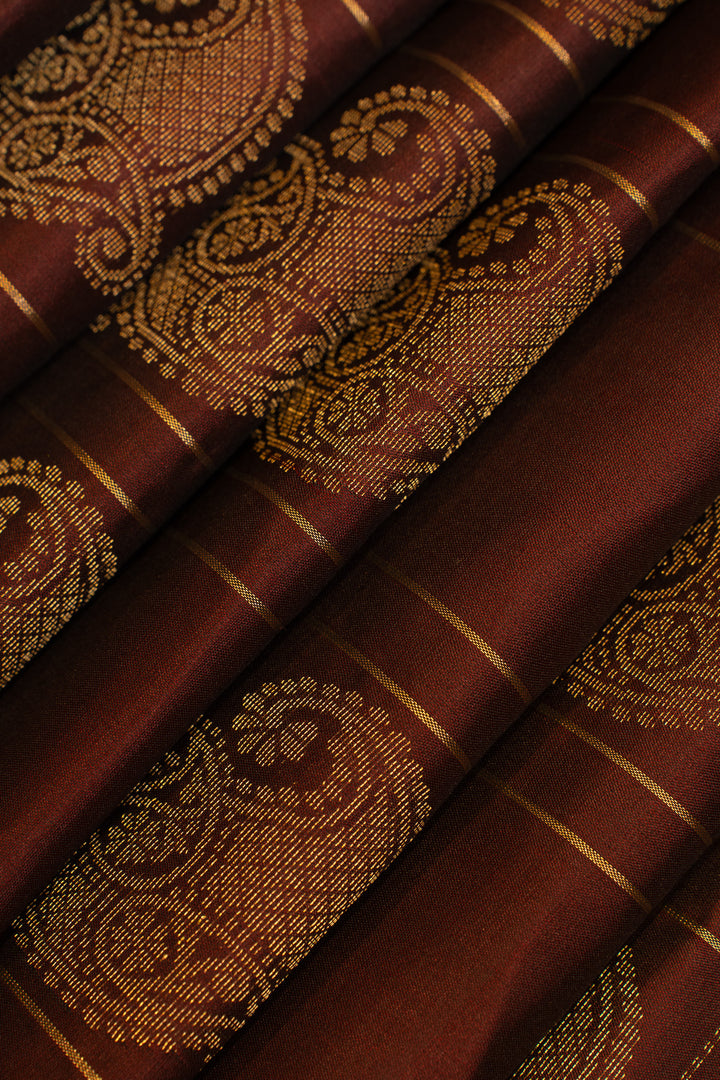 Close-up of brown fabric with gold paisley patterns