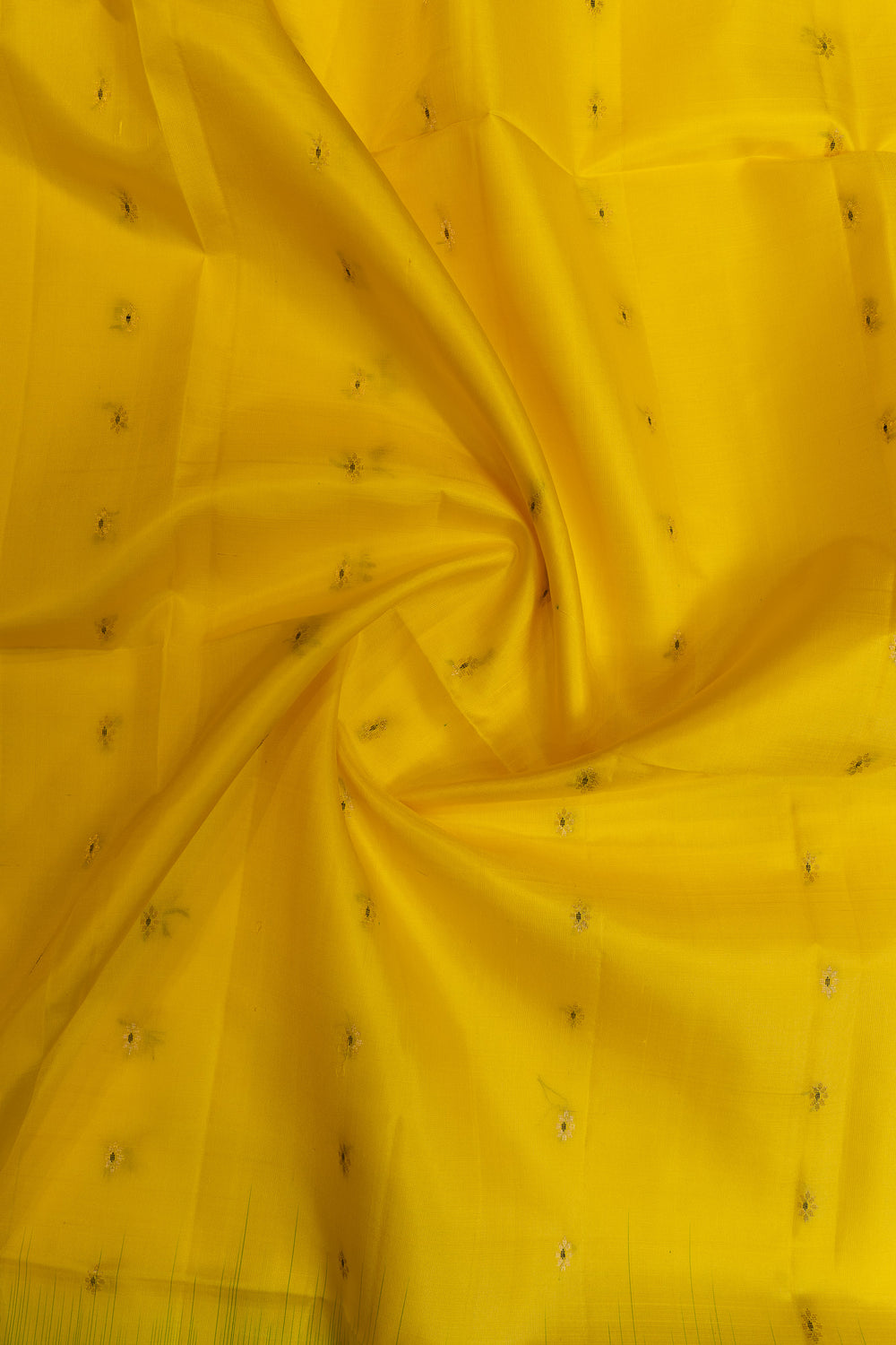 Close-up of yellow fabric with small black embellishments