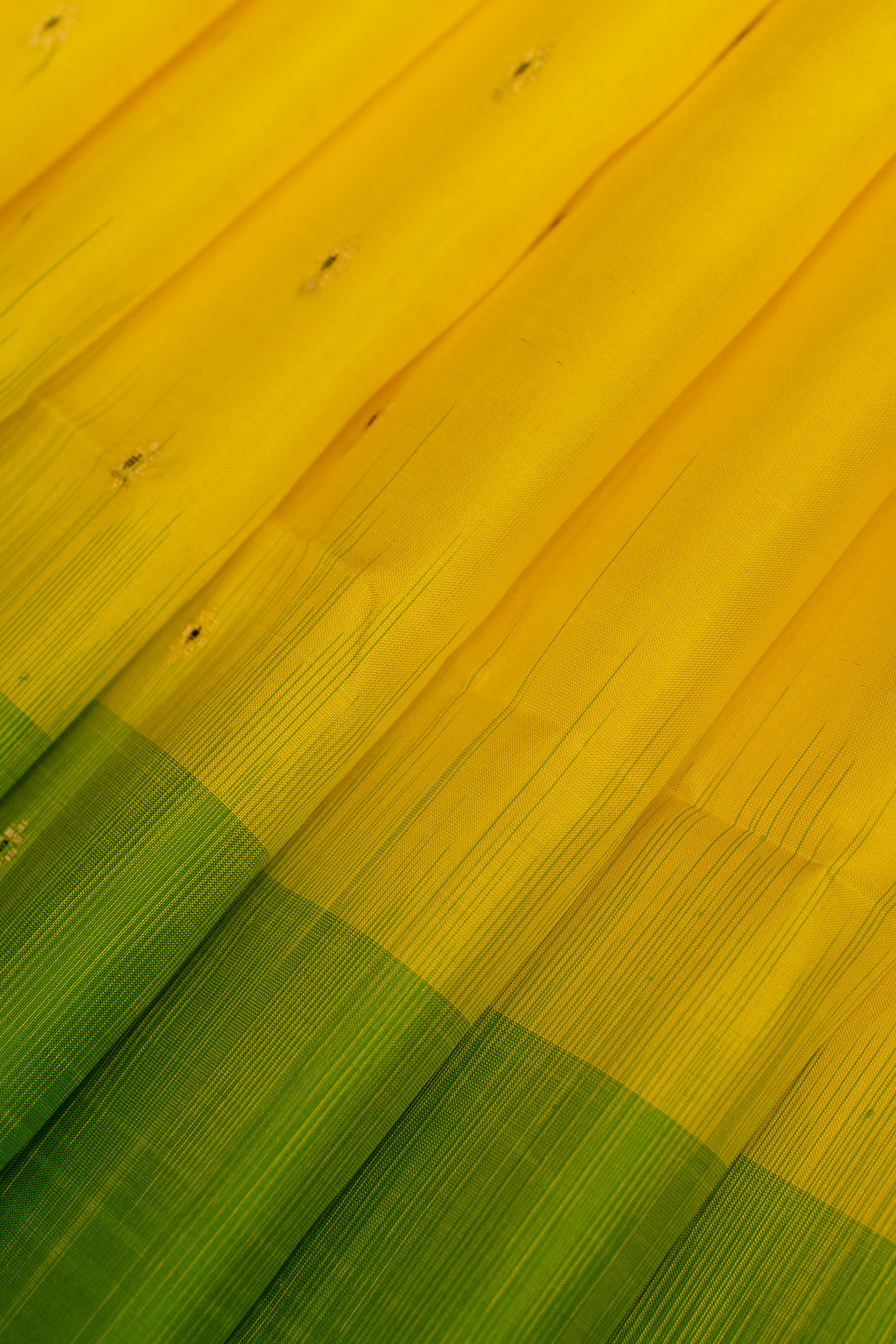 Close-up of a yellow and green woven fabric pattern