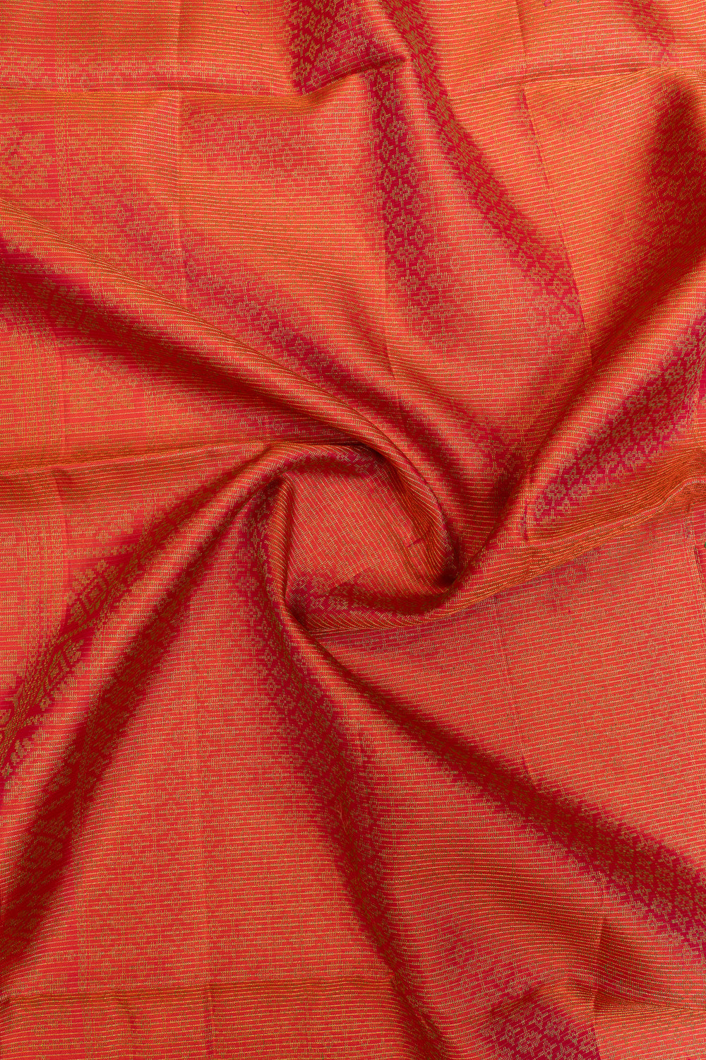 Close-up of orange fabric with a subtle pattern