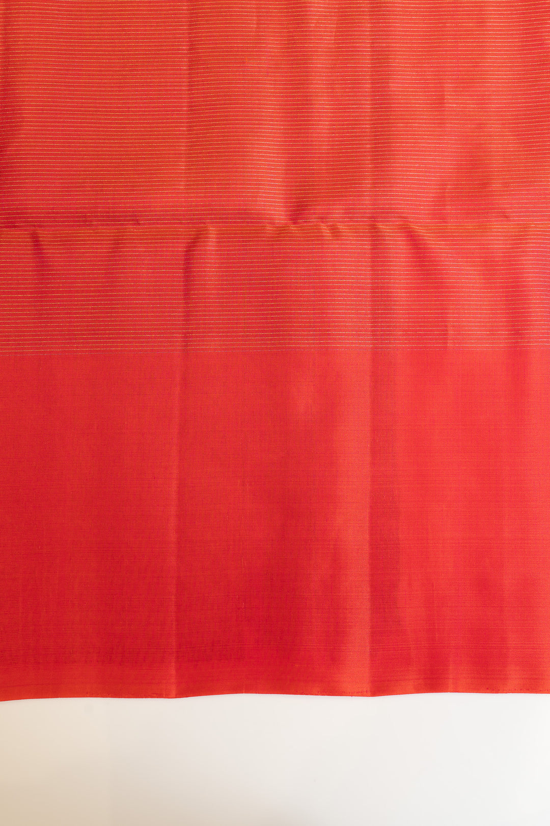Red fabric with a subtle pattern on a white background