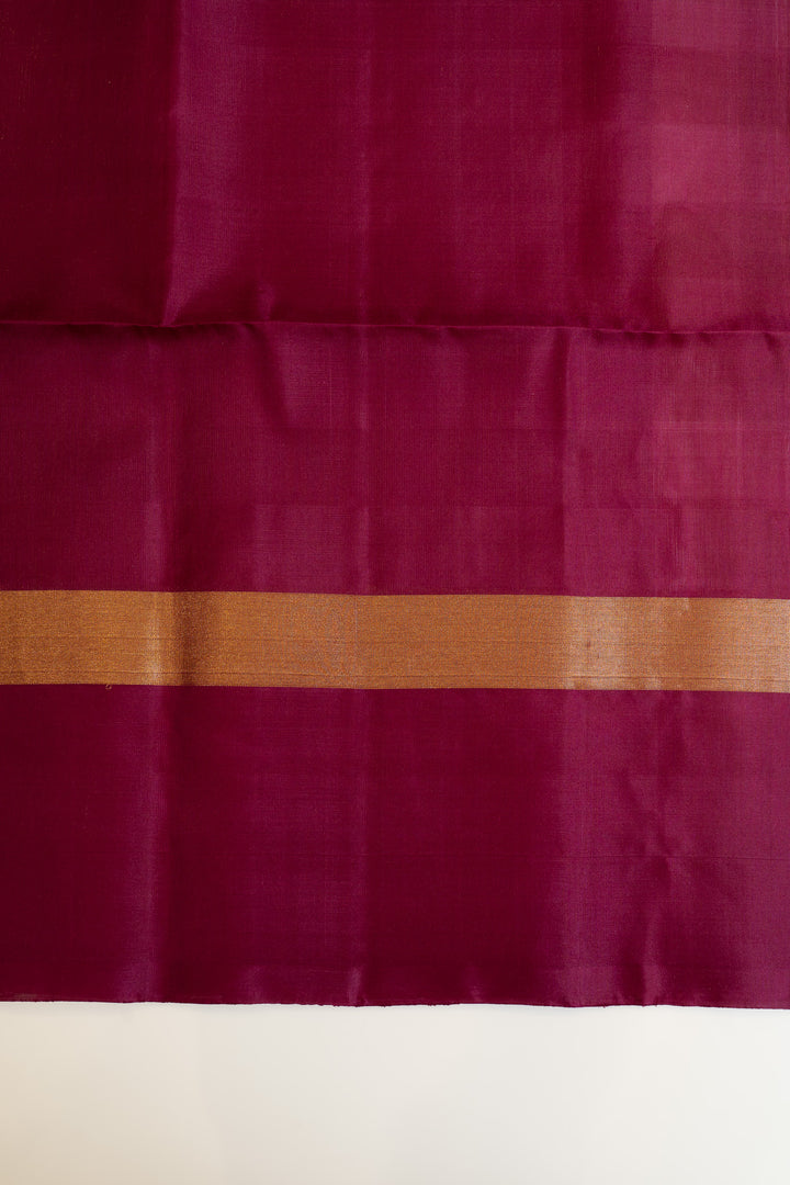 Maroon fabric with a gold border on a white background