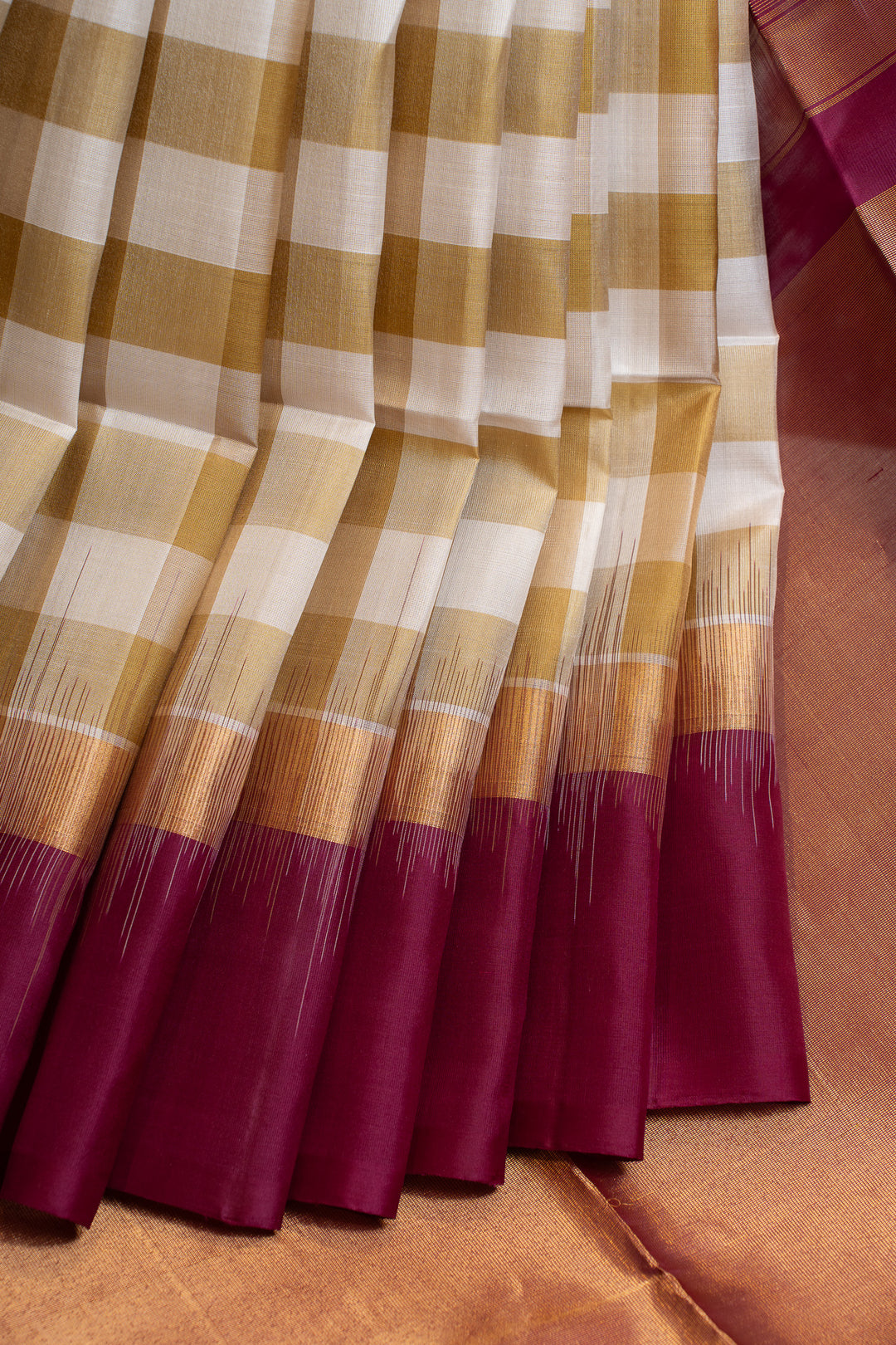 Checkered fabric with maroon at the bottom on a brown background