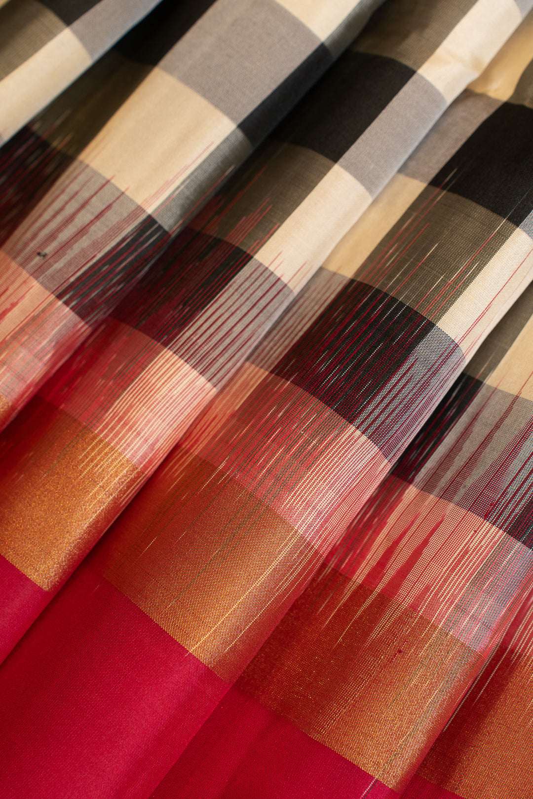 Close-up of checkered fabric with red, brown, and beige pattern