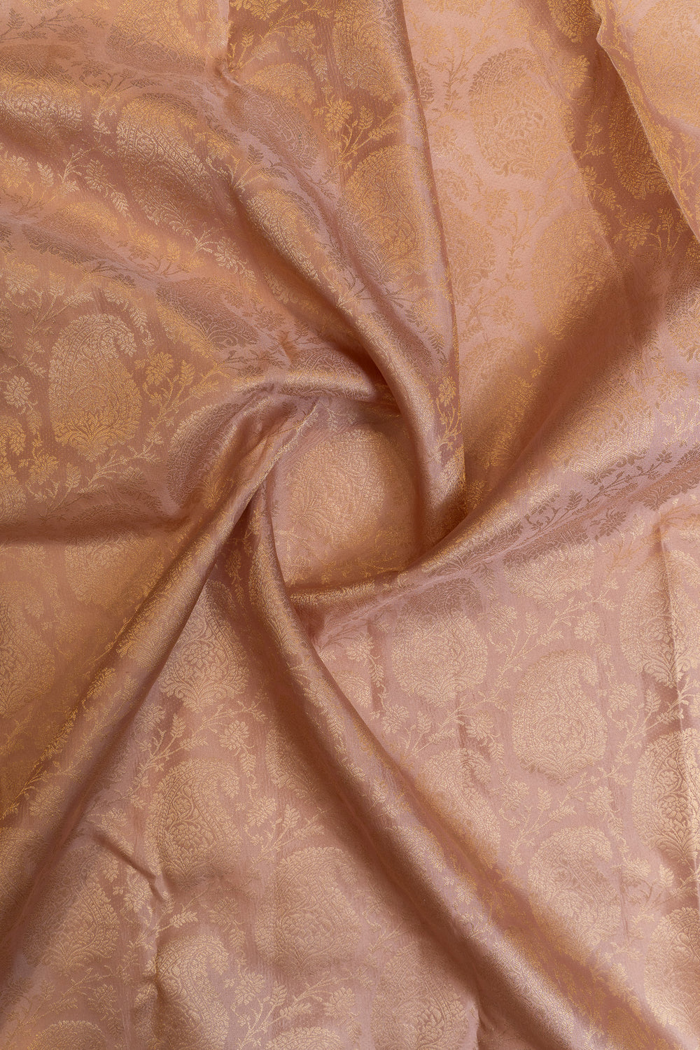Close-up of beige Kanchipuram silk saree showcasing subtle woven pattern