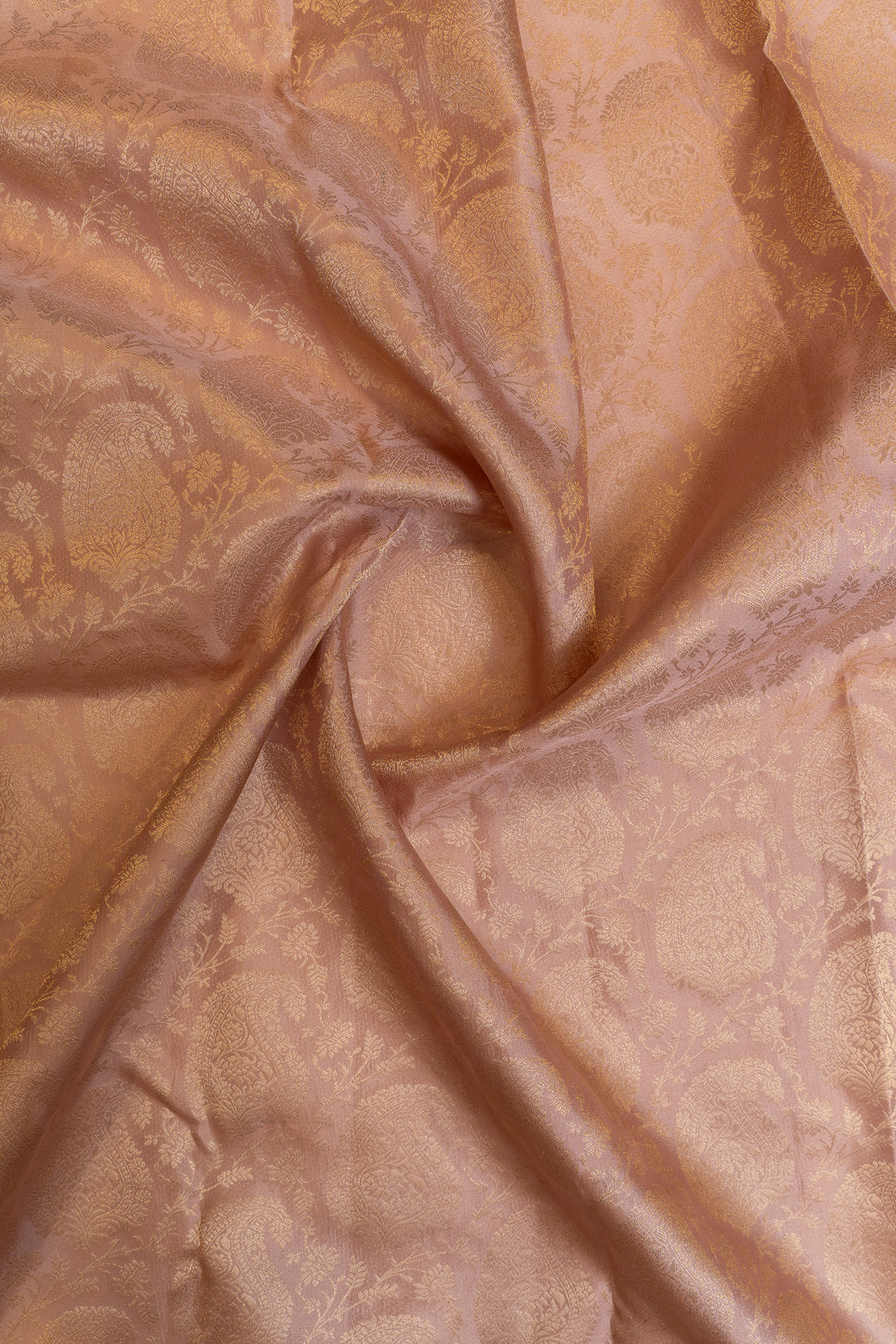Close-up of beige Kanchipuram silk saree showcasing subtle woven pattern