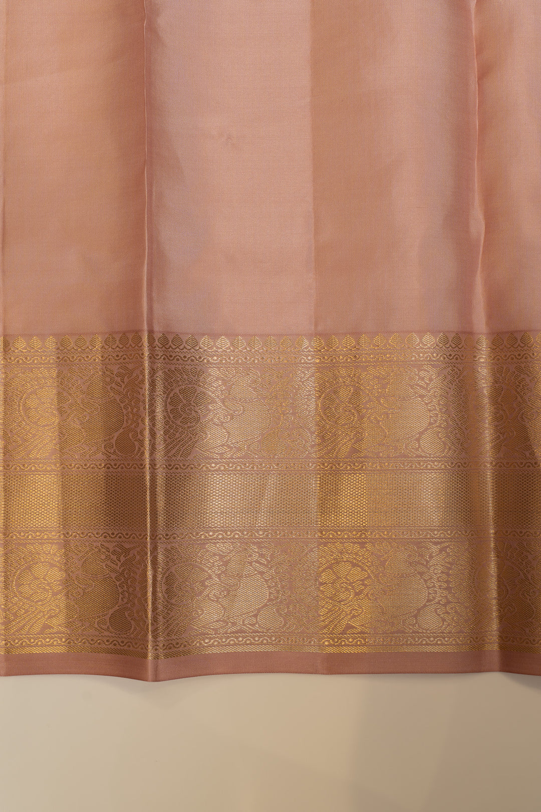 Saree with a gold border on a plain background