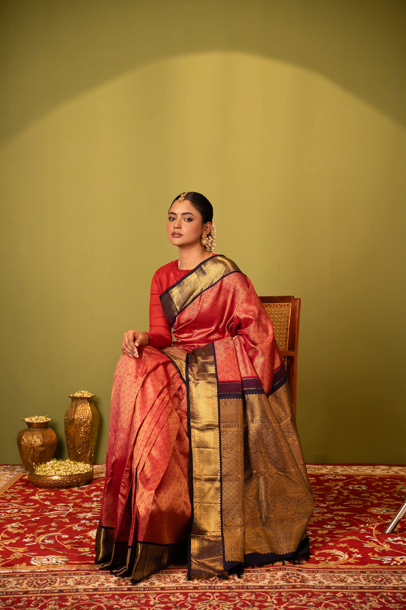 A woman gracefully wearing a Clio Silks Kanchipuram silk saree from the Eternal Saree Collection, showcasing intricate handwoven patterns and vibrant colors.