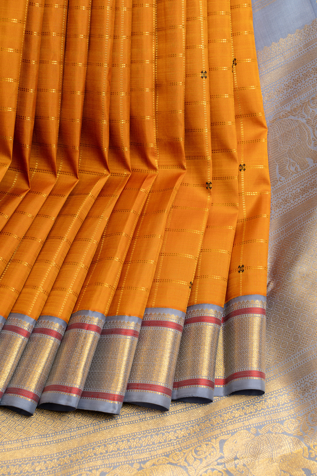 It’s orange and grey pure Kanchipuram silk saree